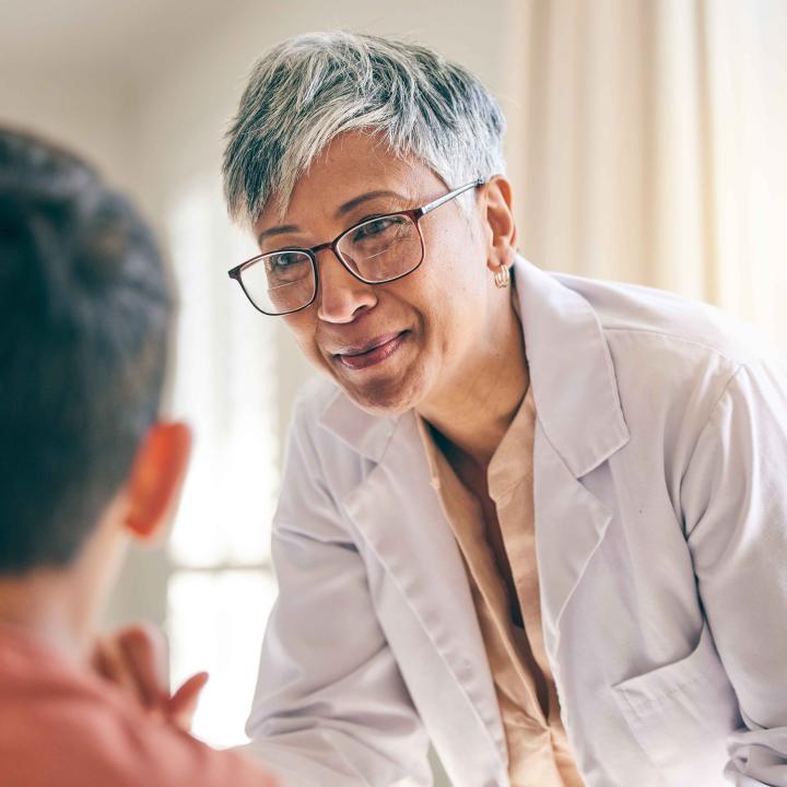 Senior female physician talking to patient