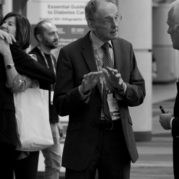 Attendee at ADA scientific session discussing research with colleague