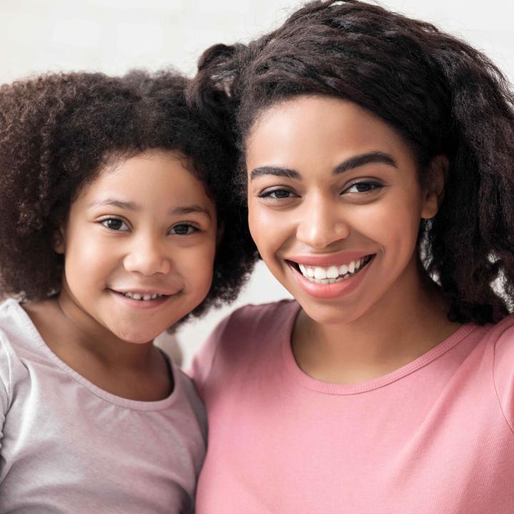 Smiling young mother with her daughter