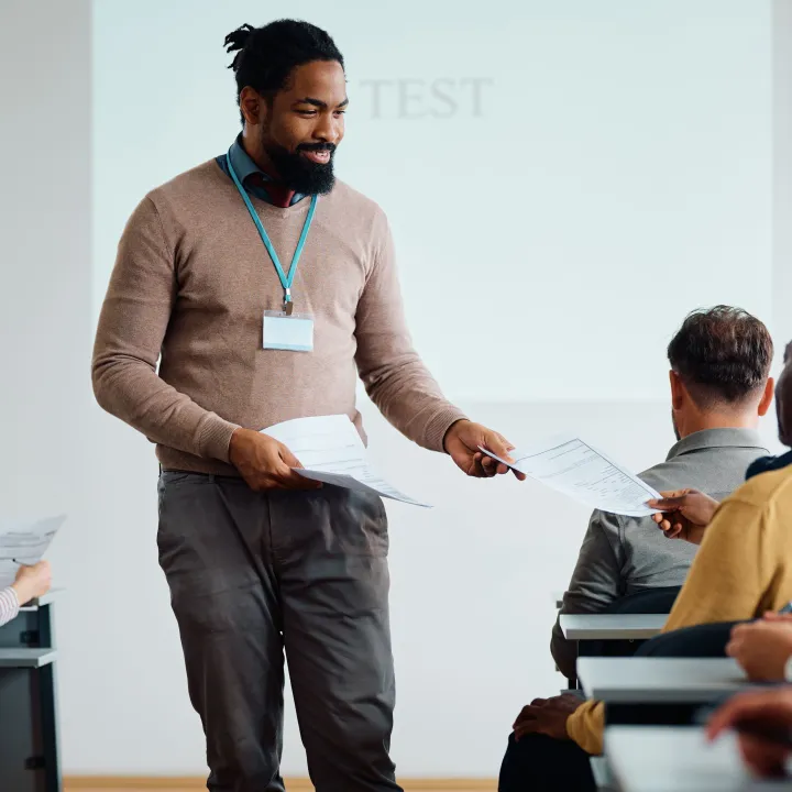 black adult education teacher handing over test