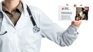 Physician holding an ADA professional postcard