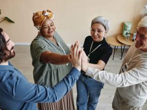 Group of seniors high-fiving each other