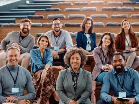 Smiling group of researchers in auditorium