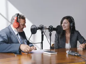 Man and woman talking on a podcast