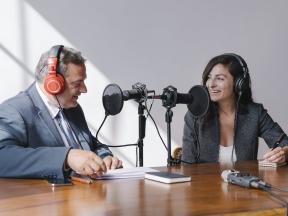 Man and woman talking on a podcast