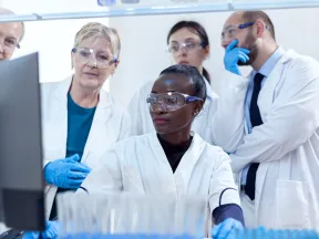 A group of diabetes researchers look at a screen