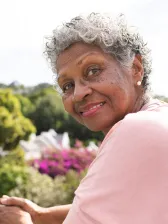 Smiling senior African American woman in garden