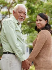 Smiling happy senior couple holding hands