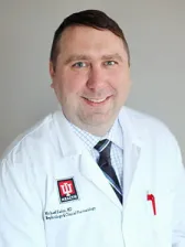 Photograph of Dr. Michael Zerin, Nephrologist/Clinical Pharmacist, smiling in a lab coat.