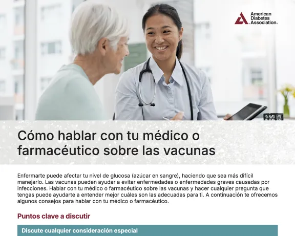 Smiling doctor talks with an older patient in a clinic.
