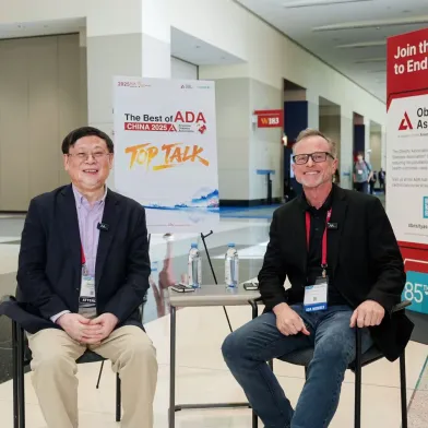 Two men smile at a conference with banners for 'The Science of ADA' and 'Join the Fight to End Obesity'.