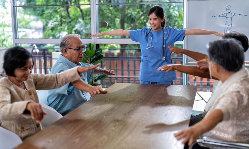 Asian health care provider leading Asian seniors through exercise