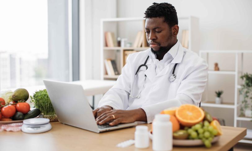 African American physician working on laptop computer