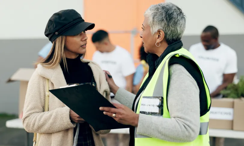 women volunteering checklist and food donation
