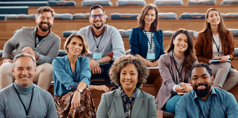 Smiling group of researchers in auditorium