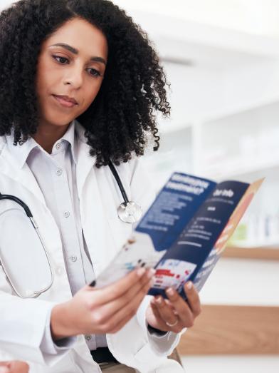 African American female physician looking at brochure