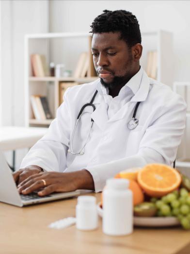 African American physician working on laptop computer