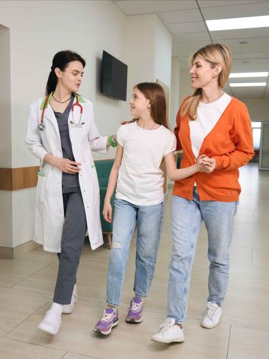 School nurse walking down hall with student