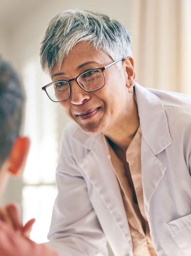 Senior female physician talking to patient