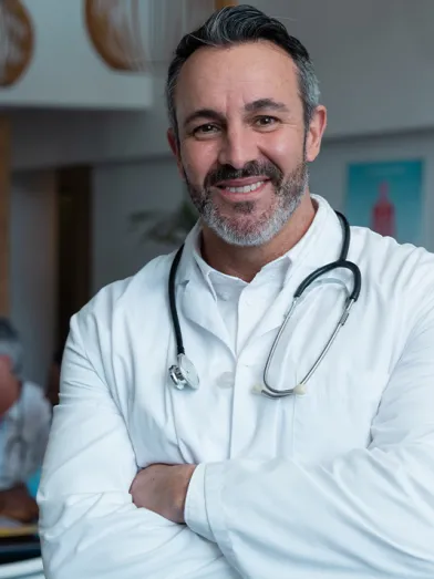 Smiling bearded doctor with stethoscope around his neck