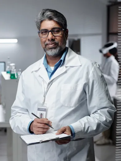 A diabetes researcher writing on a clipboard