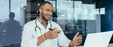 Hispanic doctor with glasses and stethoscope watching webinar